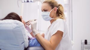 Dentist Examining Female Patient 1000x563 1